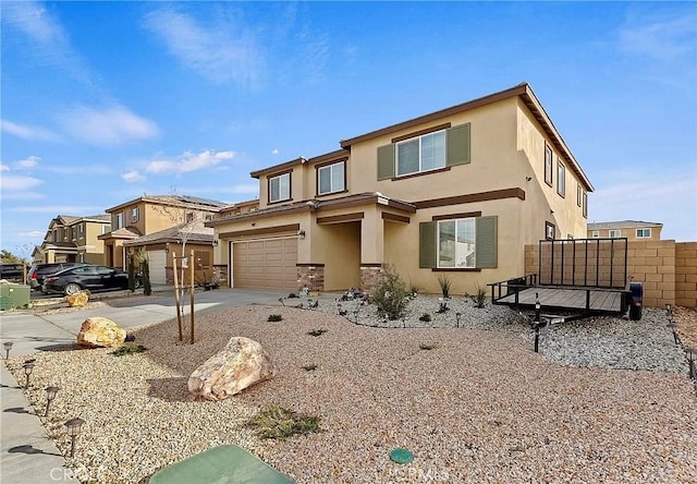 12465 Gramercy Ln, Victorville, CA 92392 - view of front of house featuring stucco siding, an attached garage, and driveway
