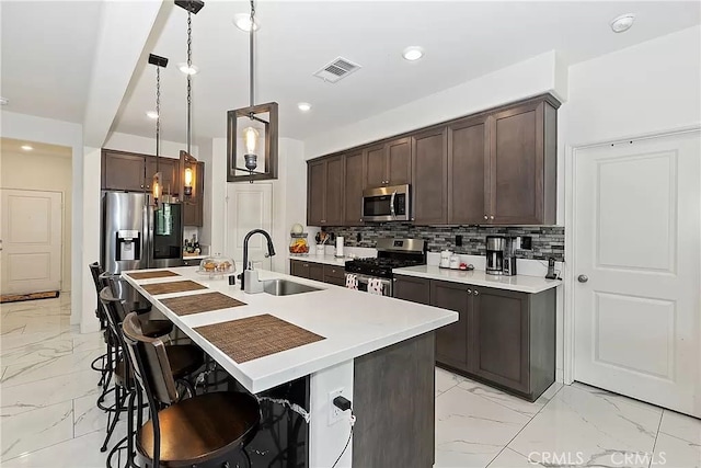 12465 Gramercy Ln, Victorville, CA 92392 - kitchen featuring stainless steel appliances, light marble finish flooring, dark brown cabinets, and recessed lighting