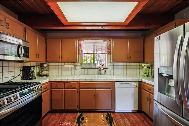 463 Delle Dr, Crestline, CA 92325 - kitchen with stainless steel appliances, dark wood-type flooring, backsplash, and light countertops