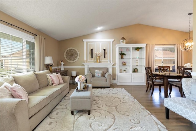 28219 Langside Ave, Canyon Country, CA 91351 - living room featuring lofted ceiling, wood finished floors, and a chandelier