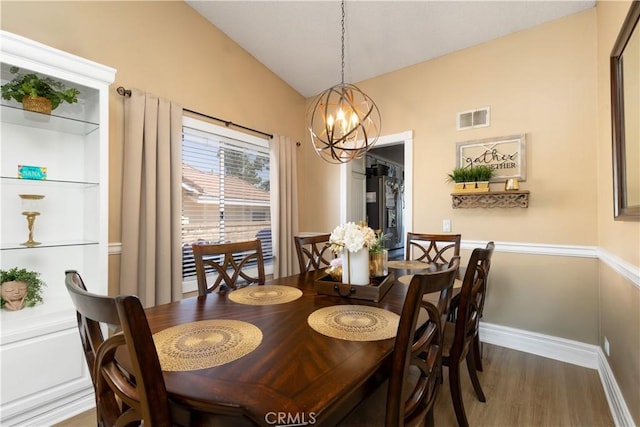 28219 Langside Ave, Canyon Country, CA 91351 - dining room with a chandelier, lofted ceiling, and wood finished floors