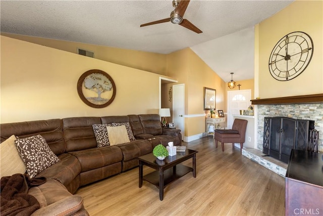 28219 Langside Ave, Canyon Country, CA 91351 - living area with light wood-style floors, lofted ceiling, ceiling fan, and a fireplace