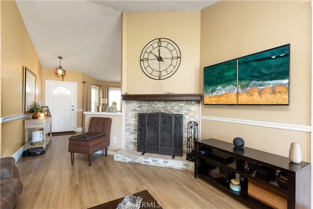 28219 Langside Ave, Canyon Country, CA 91351 - living room with wood finished floors, vaulted ceiling, and a fireplace