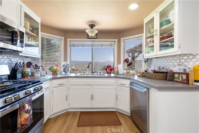 28219 Langside Ave, Canyon Country, CA 91351 - kitchen featuring appliances with stainless steel finishes, white cabinets, decorative backsplash, light wood-style floors, and recessed lighting