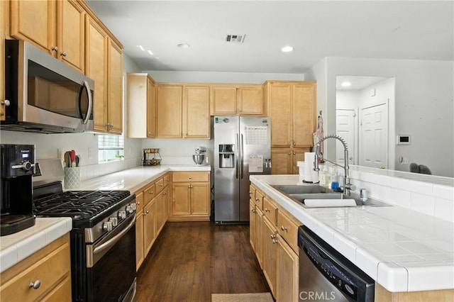 16074 Coyote Springs Ct, Moreno Valley, CA 92551 - kitchen with stainless steel appliances, dark wood finished floors, tile counters, recessed lighting, and light brown cabinets