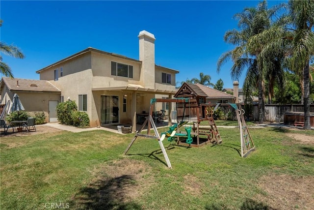 16074 Coyote Springs Ct, Moreno Valley, CA 92551 - rear view of property featuring stucco siding, a playground, a patio area, and a chimney