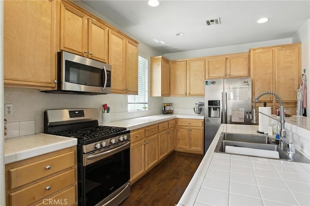 16074 Coyote Springs Ct, Moreno Valley, CA 92551 - kitchen featuring appliances with stainless steel finishes, tile countertops, recessed lighting, and dark wood finished floors