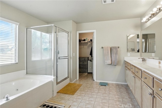 16074 Coyote Springs Ct, Moreno Valley, CA 92551 - bathroom with a stall shower, double vanity, a jetted tub, a walk in closet, and tile patterned flooring