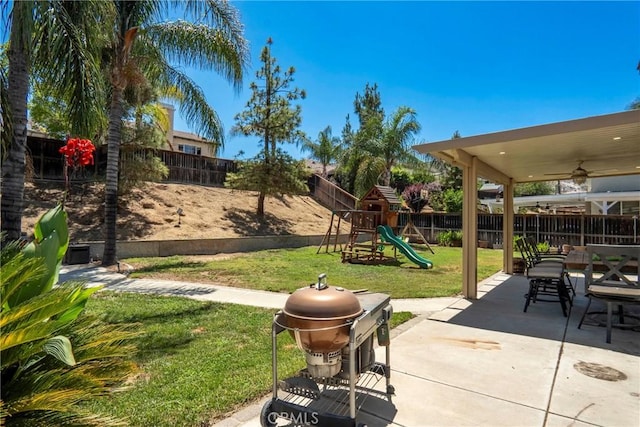 16074 Coyote Springs Ct, Moreno Valley, CA 92551 - fenced backyard featuring a playground, a patio, a grill, ceiling fan, and outdoor dining area