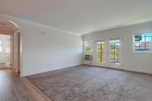 506 Canyon Dr Unit 70, Oceanside, CA 92054 - unfurnished room with arched walkways, crown molding, healthy amount of natural light, french doors, and an AC wall unit