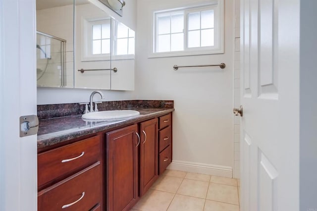 506 Canyon Dr Unit 70, Oceanside, CA 92054 - bathroom featuring healthy amount of natural light, vanity, tile patterned flooring, and a shower with door