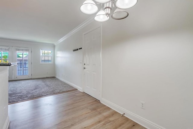 506 Canyon Dr Unit 70, Oceanside, CA 92054 - carpeted foyer featuring ornamental molding, a chandelier, and wood finished floors