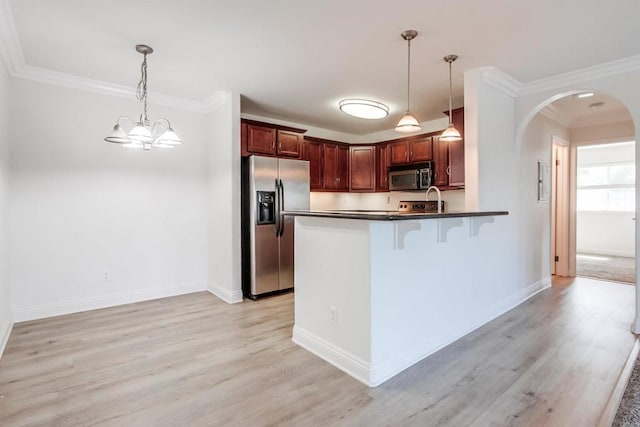 506 Canyon Dr Unit 70, Oceanside, CA 92054 - kitchen with stainless steel appliances, arched walkways, dark countertops, light wood finished floors, and ornamental molding