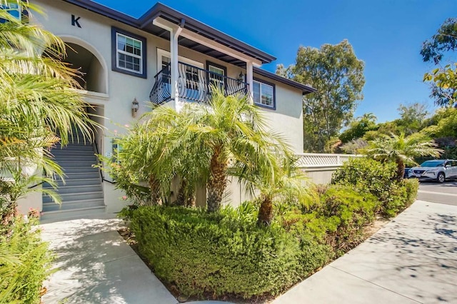 506 Canyon Dr Unit 70, Oceanside, CA 92054 - view of front of property featuring a balcony, stucco siding, and stairway