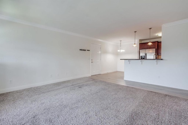 506 Canyon Dr Unit 70, Oceanside, CA 92054 - unfurnished living room featuring crown molding, light carpet, and a chandelier