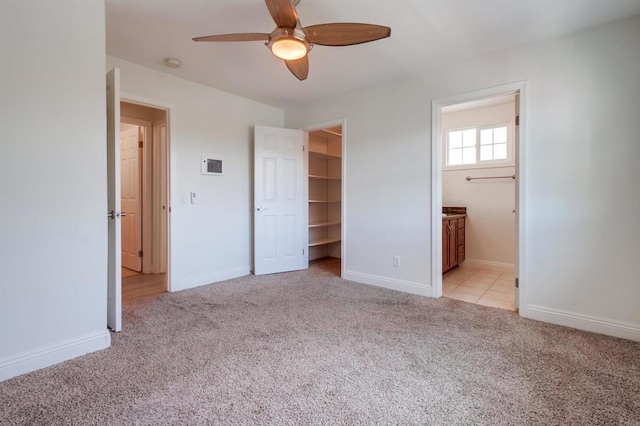 506 Canyon Dr Unit 70, Oceanside, CA 92054 - unfurnished bedroom with light colored carpet, a walk in closet, a ceiling fan, and connected bathroom
