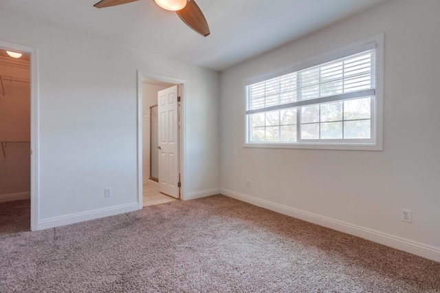 506 Canyon Dr Unit 70, Oceanside, CA 92054 - unfurnished bedroom with a walk in closet, light colored carpet, connected bathroom, and ceiling fan