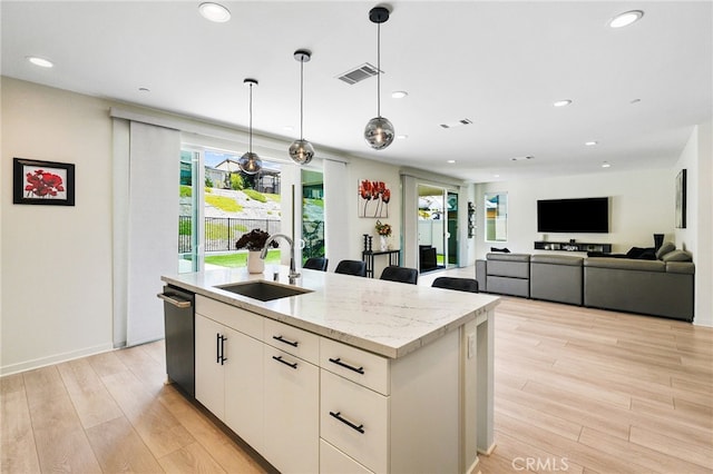28508 Daybreak Way, Saugus, CA 91350 - kitchen featuring an island with sink, light wood finished floors, recessed lighting, decorative light fixtures, and dishwasher
