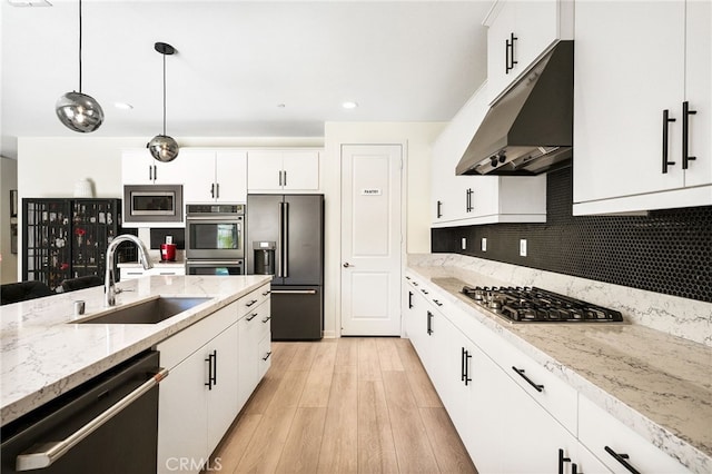 28508 Daybreak Way, Saugus, CA 91350 - kitchen featuring stainless steel appliances, under cabinet range hood, light wood-style flooring, white cabinetry, and tasteful backsplash