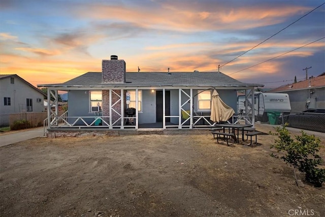 24976 7th St, San Bernardino, CA 92410 - view of front of home featuring a chimney, a porch, and stucco siding