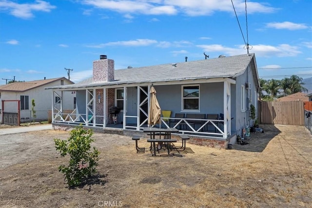 24976 7th St, San Bernardino, CA 92410 - rear view of property featuring a chimney