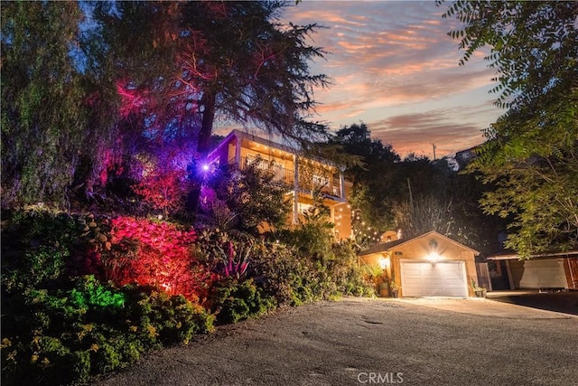 24058 Eagle Mountain St, West Hills, CA 91304 - view of property hidden behind natural elements featuring concrete driveway