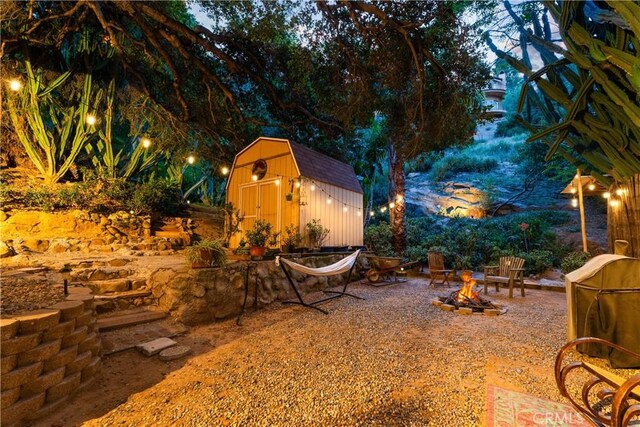 24058 Eagle Mountain St, West Hills, CA 91304 - view of yard featuring an outdoor fire pit and a storage shed