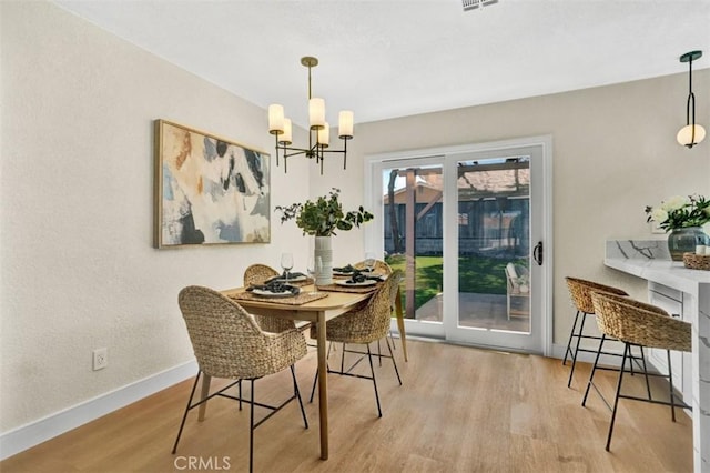 10965 Canis Ln, San Diego, CA 92126 - dining area featuring a chandelier, wood finished floors, and a textured wall