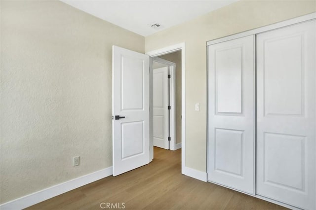 10965 Canis Ln, San Diego, CA 92126 - unfurnished bedroom with wood finished floors and a closet