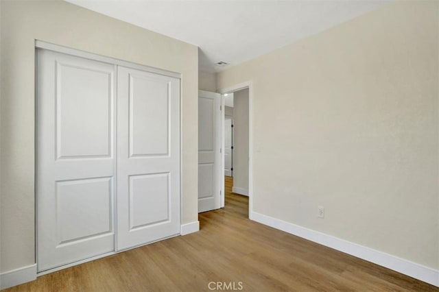 10965 Canis Ln, San Diego, CA 92126 - unfurnished bedroom featuring wood finished floors and a closet