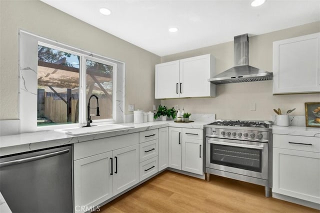 10965 Canis Ln, San Diego, CA 92126 - kitchen featuring wall chimney exhaust hood, appliances with stainless steel finishes, light stone counters, white cabinets, and recessed lighting
