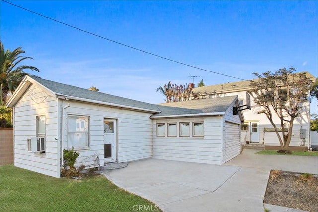 853 S Lemon St, Anaheim, CA 92805 - rear view of house featuring a patio area, a shingled roof, and cooling unit