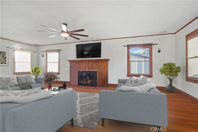 853 S Lemon St, Anaheim, CA 92805 - living room with a ceiling fan, wood finished floors, plenty of natural light, a glass covered fireplace, and crown molding