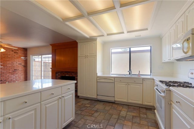 227 Gable Ln, La Habra, CA 90631 - kitchen with white appliances, light countertops, plenty of natural light, white cabinetry, and brick wall