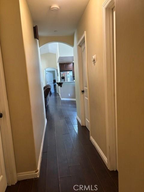 10401 Hemlock Ave, Hesperia, CA 92345 - hallway with arched walkways and dark wood-type flooring