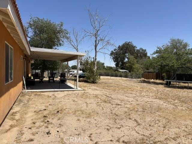 10401 Hemlock Ave, Hesperia, CA 92345 - view of yard with a trampoline and a patio area