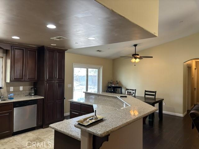 10401 Hemlock Ave, Hesperia, CA 92345 - kitchen featuring stainless steel dishwasher, arched walkways, a breakfast bar area, a large island, and recessed lighting