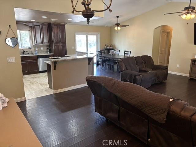 10401 Hemlock Ave, Hesperia, CA 92345 - living area featuring a ceiling fan, arched walkways, healthy amount of natural light, and lofted ceiling