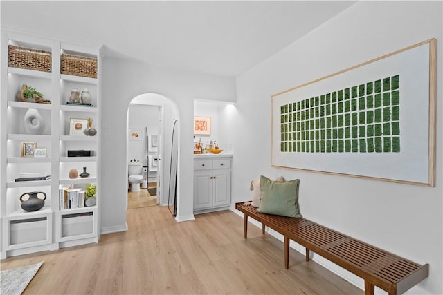 625 N Flores St Unit 202, West Hollywood, CA 90048 - living area with arched walkways and light wood-style floors