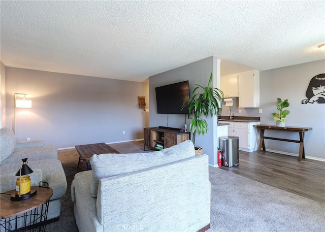12200 Montecito Rd Unit D320, Seal Beach, CA 90740 - living room featuring a textured ceiling and dark carpet