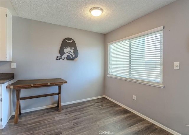 12200 Montecito Rd Unit D320, Seal Beach, CA 90740 - unfurnished dining area with a textured ceiling and wood finished floors
