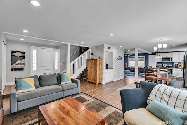 3609 S Parton St, Santa Ana, CA 92707 - living room with stairway, dark wood finished floors, recessed lighting, a chandelier, and ceiling fan
