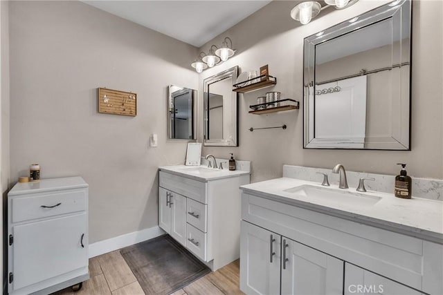 3609 S Parton St, Santa Ana, CA 92707 - full bathroom featuring two vanities and wood finished floors