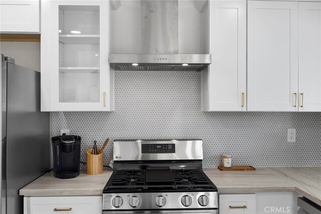 16228 Plummer St, North Hills, CA 91343 - kitchen with stainless steel appliances, wall chimney range hood, tasteful backsplash, and white cabinetry