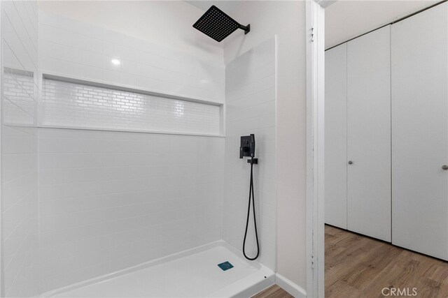 16228 Plummer St, North Hills, CA 91343 - bathroom with a tile shower and wood finished floors