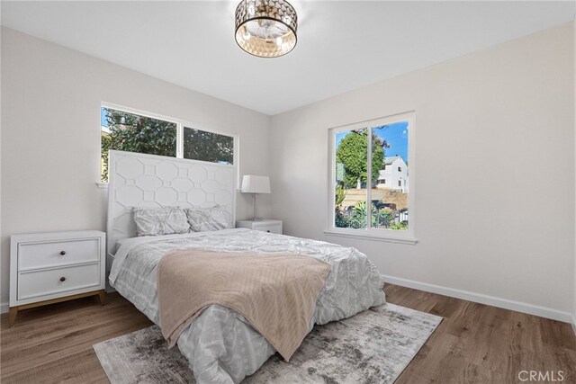16228 Plummer St, North Hills, CA 91343 - bedroom featuring multiple windows and wood finished floors