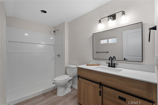 16228 Plummer St, North Hills, CA 91343 - full bathroom with wood finished floors, vanity, and a shower