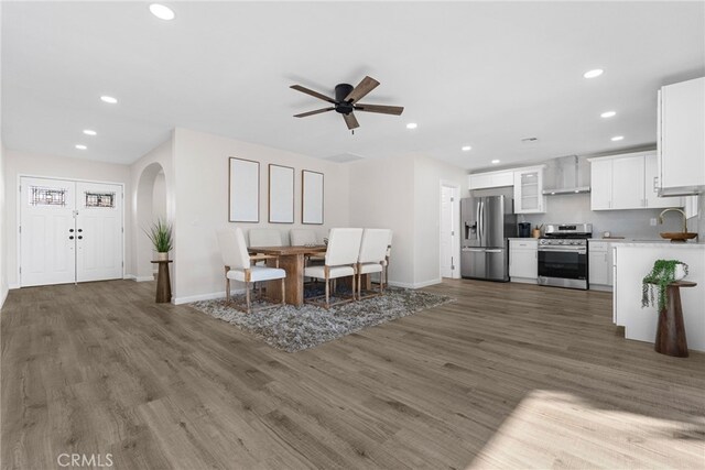 16228 Plummer St, North Hills, CA 91343 - dining room featuring arched walkways, recessed lighting, wood finished floors, and ceiling fan