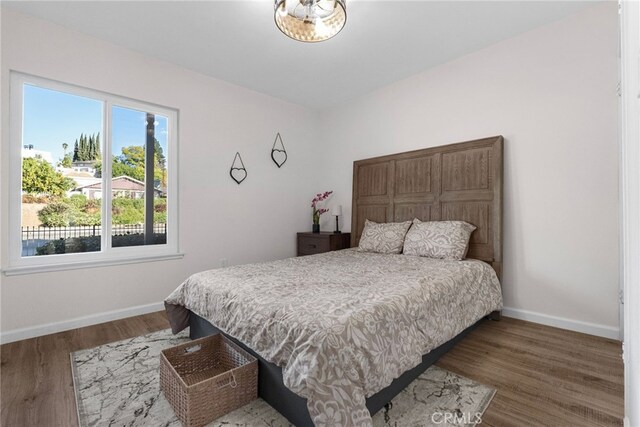 16228 Plummer St, North Hills, CA 91343 - bedroom featuring baseboards and wood finished floors