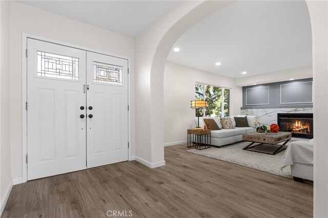 16228 Plummer St, North Hills, CA 91343 - entryway with wood finished floors, arched walkways, recessed lighting, and a fireplace